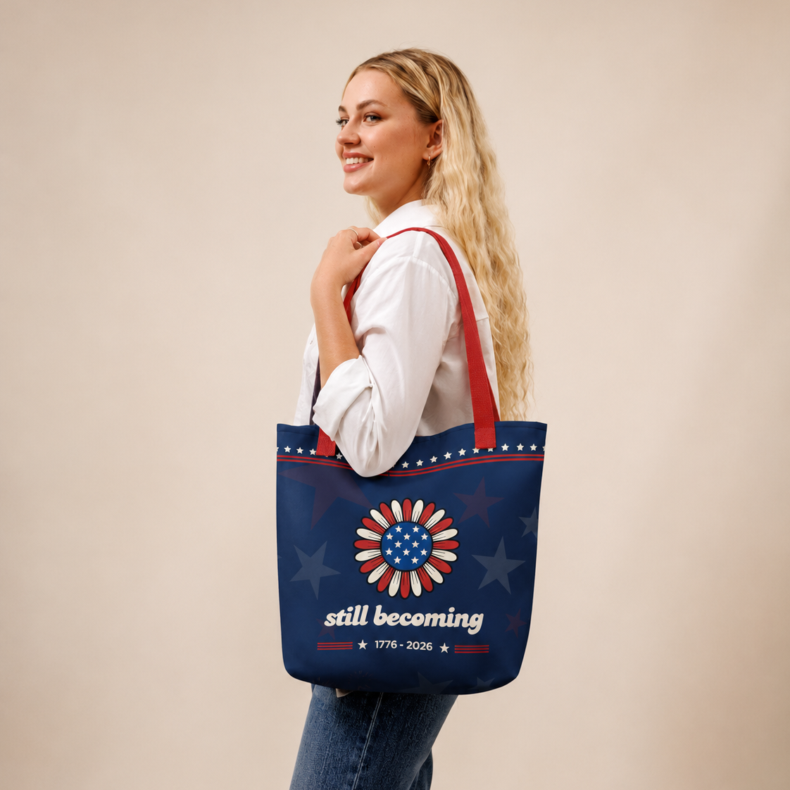 Woman holding a blue tote bag with a sunflower design and text on a beige background